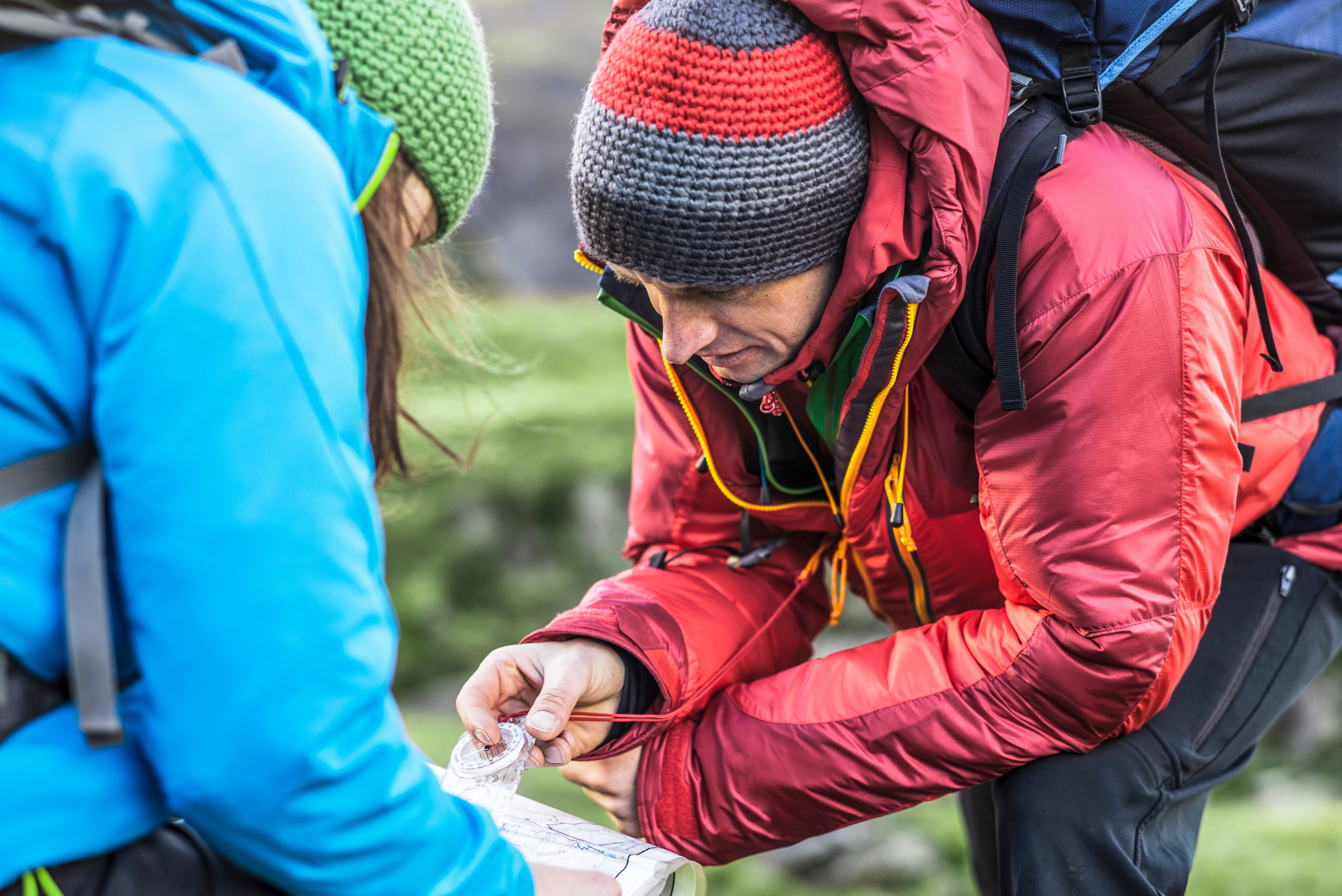 Mountain runner and running guide on a navigation course for runners in the lake district looking at the map